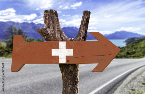 Switzerland wooden sign with a street background photo