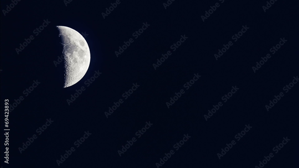 Time lapse of an large moon as it rises in the black night sky Time lapse of an large moon as it rises in the black night sky