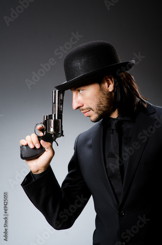 Man with gun and vintage hat