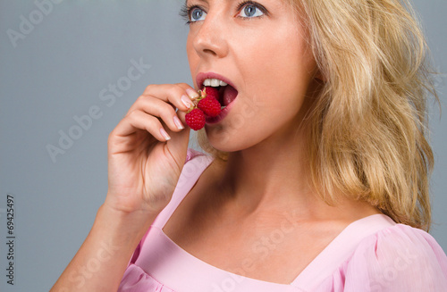 Woman eating raspberries
