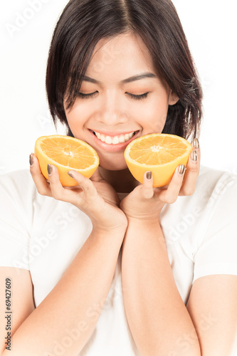 Young woman holding fresh oranges. Healthy eating. Isolated over