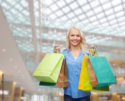 smiling woman with many shopping bags