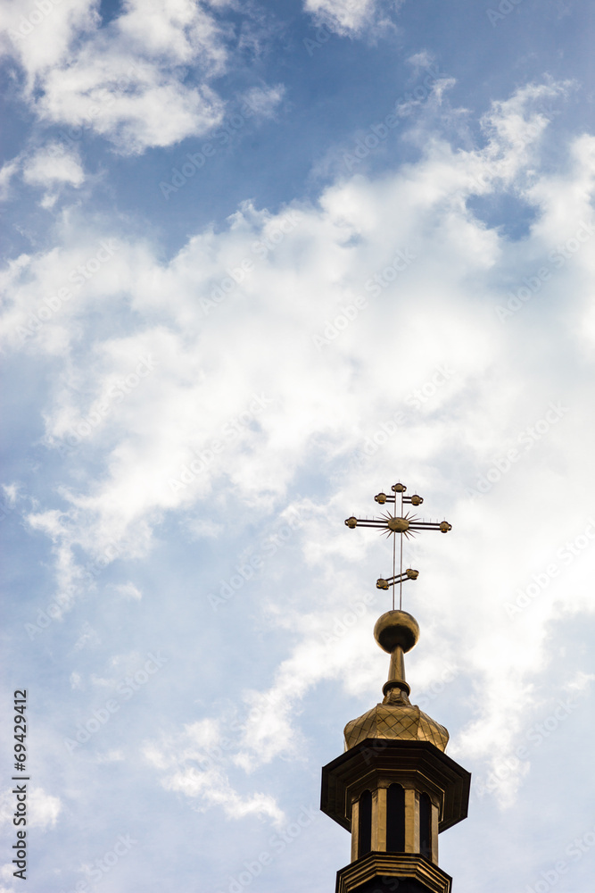 The cross of the orthodox Christian church against the cloudy sk