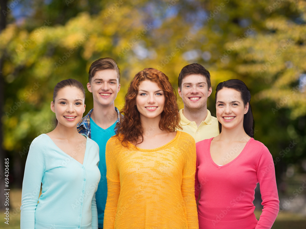 group of smiling teenagers over green park group of smiling teenagers over green park