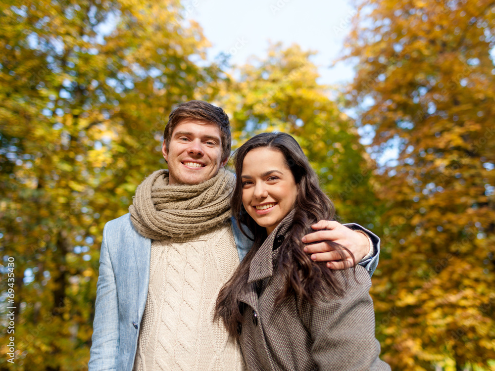 smiling couple hugging in autumn park smiling couple hugging in autumn park