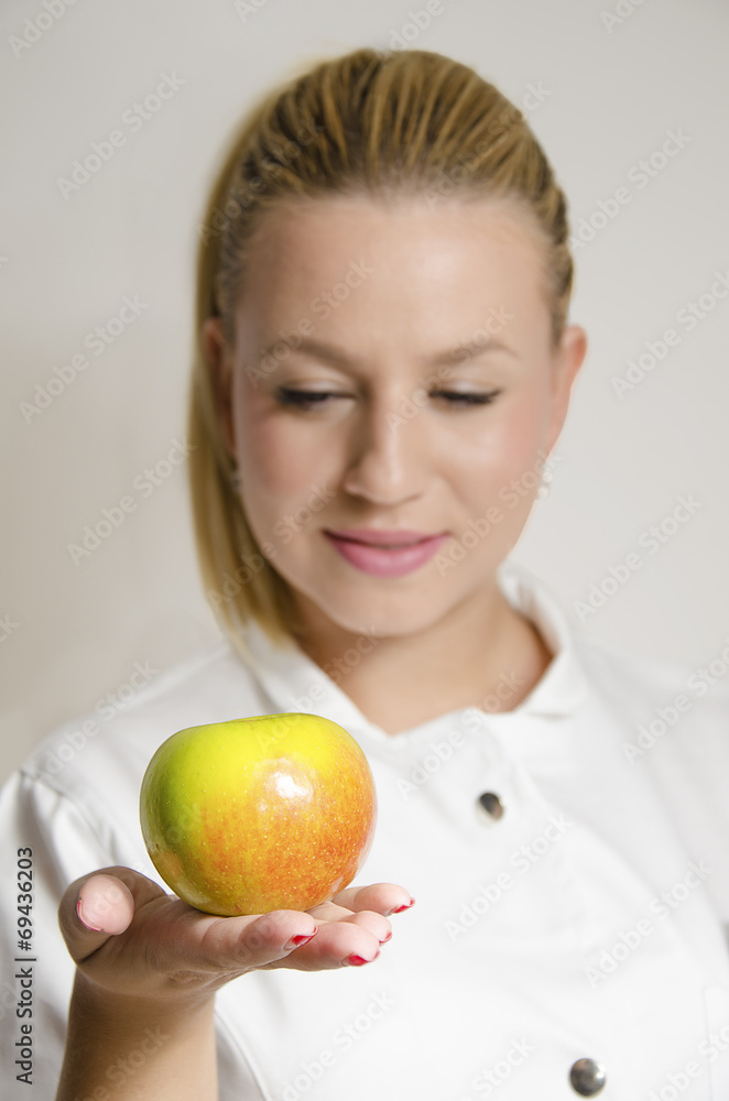 Nurse giving an apple focus on apple Nurse giving an apple focus on apple