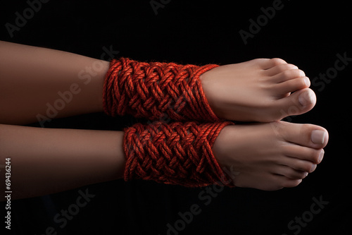 Two female legs shibari.