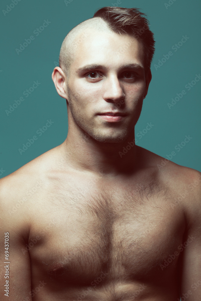 Fototapeta premium Male beauty concept. Handsome male model with half-shaved head