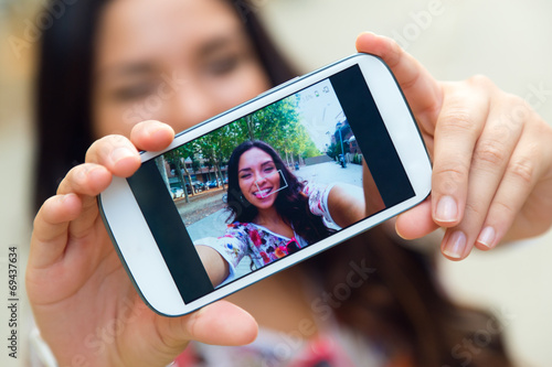 Pretty student girl taking a selfie.