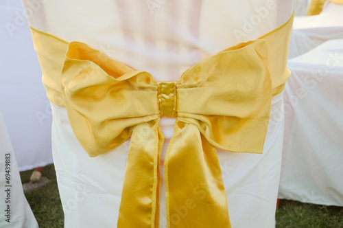 The back of yellow and gold wedding chairs