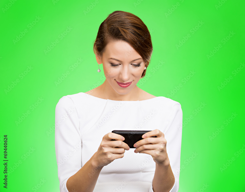 Woman texting on smart phone on green background Woman texting on smart phone on green background