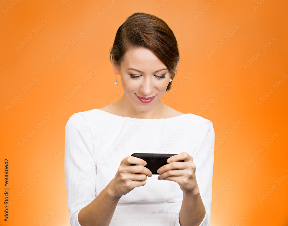 Woman texting on smart phone on orange background Woman texting on smart phone on orange background