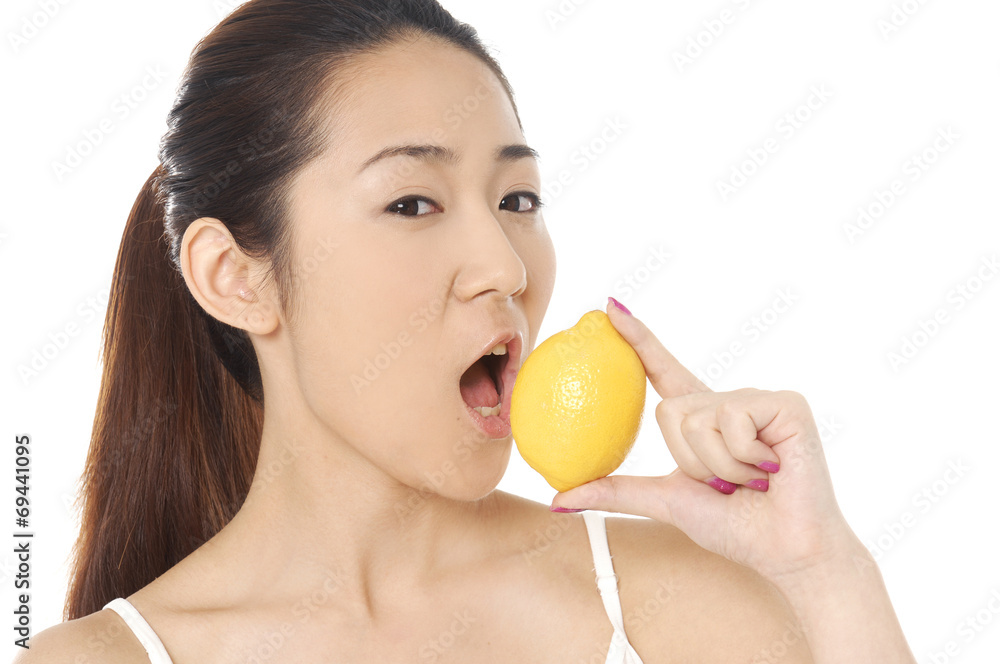 young woman her pretty face and holding lemon young woman her pretty face and holding lemon