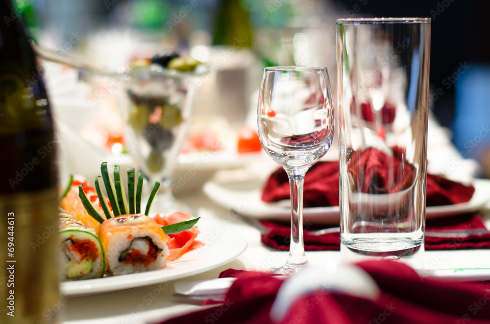 Sushi and glasses on a formal dining table