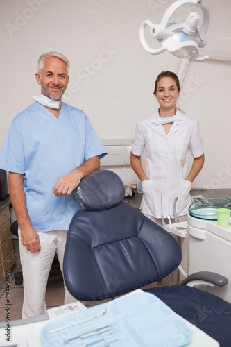 Dentist and assistant smiling at camera