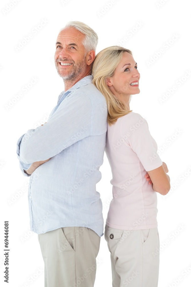 Smiling couple standing leaning backs together Smiling couple standing leaning backs together
