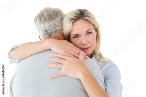 Unhappy blonde hugging her husband