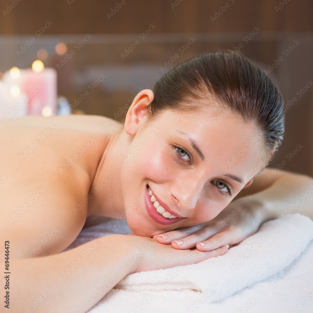 Beautiful woman lying on massage table at spa center Beautiful woman lying on massage table at spa center