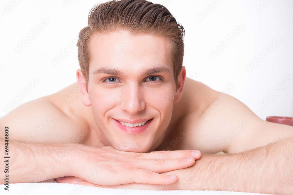 Handsome man lying on the massage desks. Handsome man lying on the massage desks.