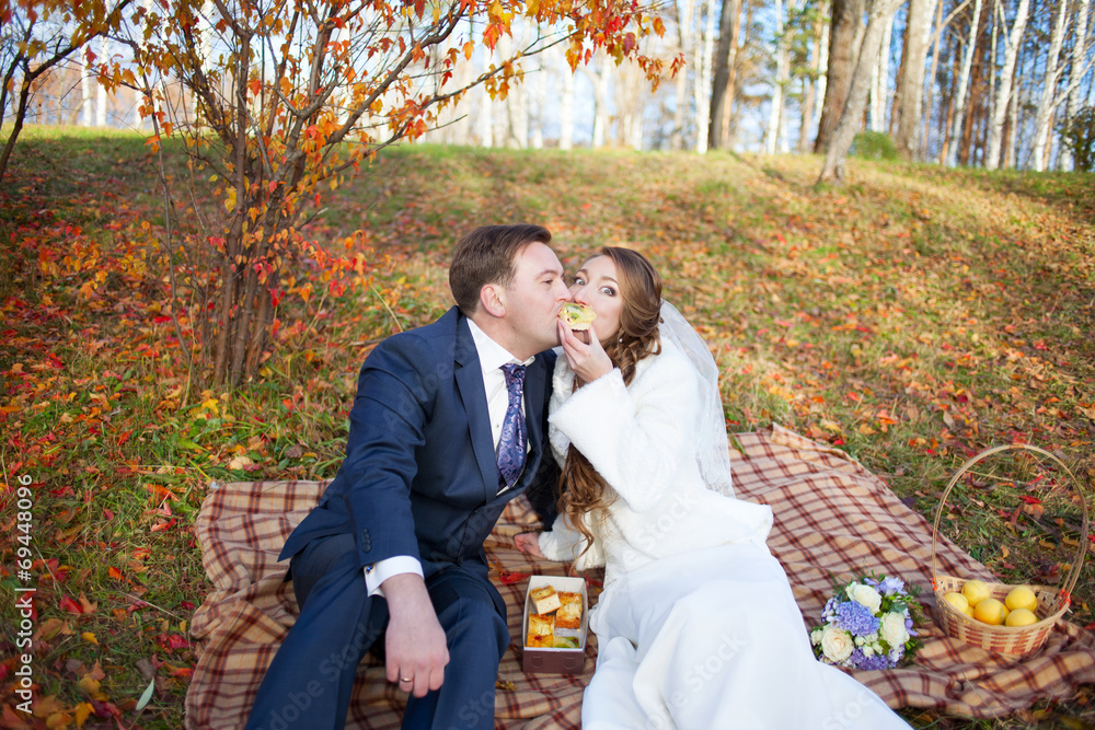 Fun portrait of happy wedding couple in autumn forest