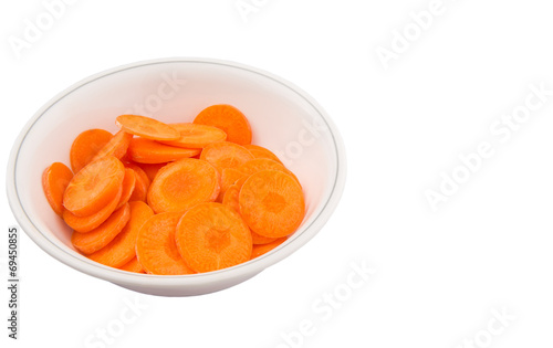 Chopped carrot in a bowl over white background