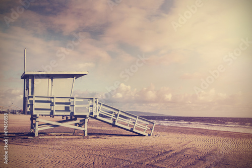 Vintage retro picture of wooden lifeguard tower, Beach in California, USA.