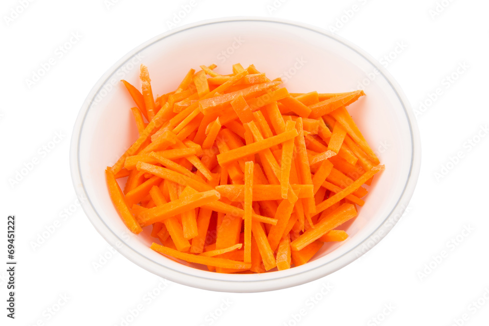 Chopped carrot in a bowl over white background