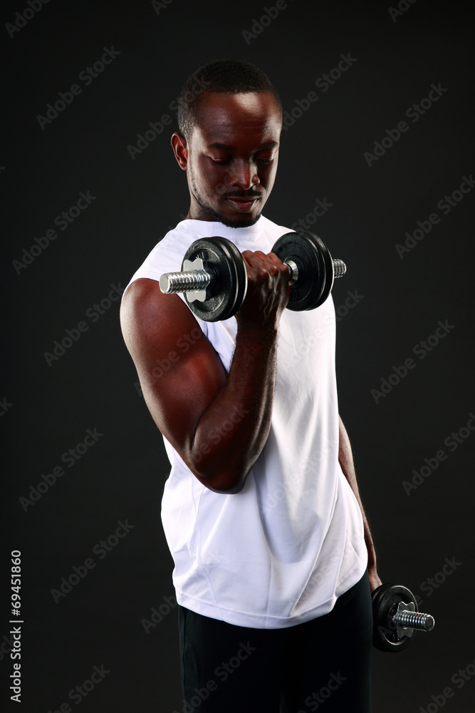 Portrait of african man working out with dumbbells