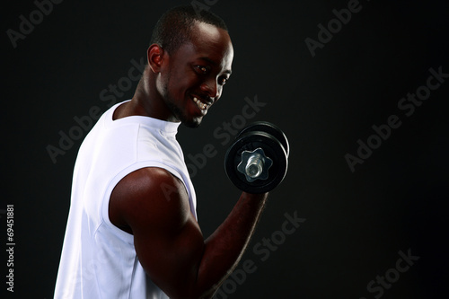 handsome african sports man over black background