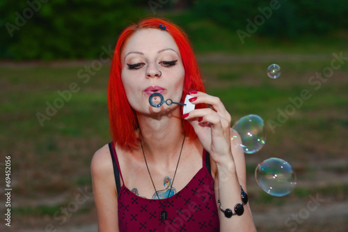 Pretty Girl Blows Bubble near the river