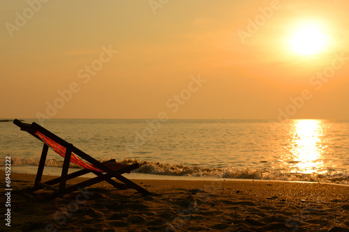Silhouette of beach chair and sunset © dangdumrong