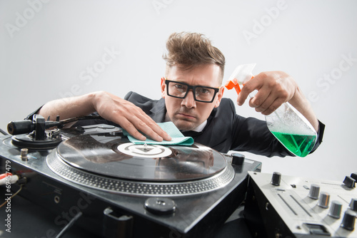 DJ in tuxedo cleaning his turntable