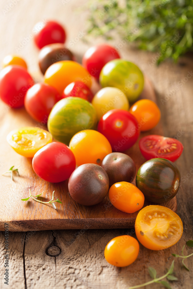 colorful tomatoes over wooden background colorful tomatoes over wooden background
