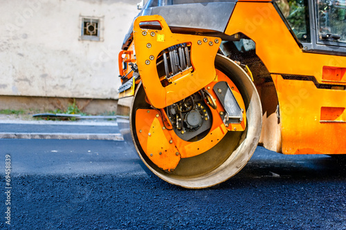 Heavy Tandem Vibration roller compactor at asphalt pavement work © aboutmomentsimages