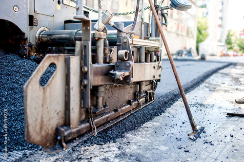 close-up of asphalting machinery and tools working at industrial