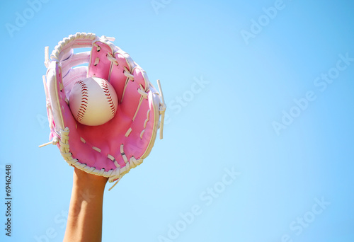Photography Hand of Baseball Player with Pink Glove and Ball over Blue Sky