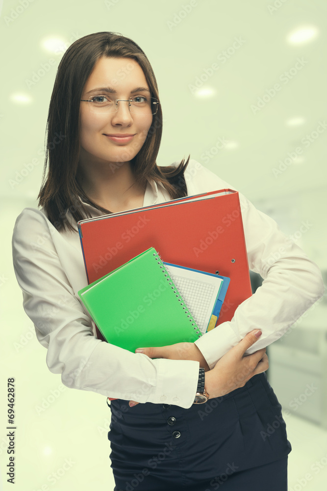 Fototapeta premium Young woman secretary at work at the office