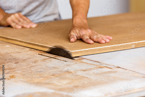 carpenter use saw cut wood for make new furniture