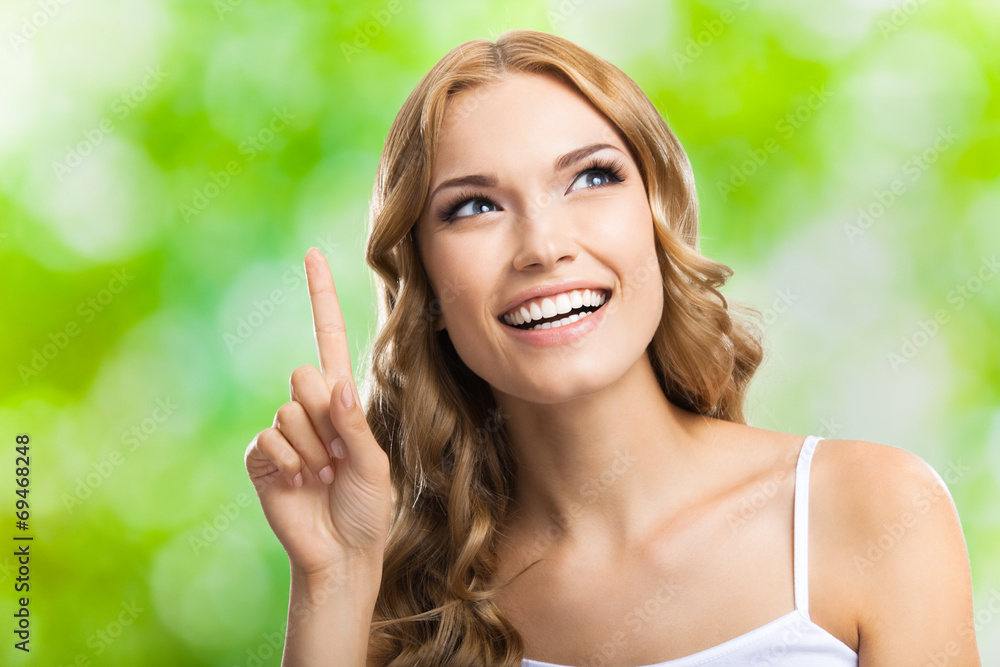 Woman, showing one finger or idea gesture, outdoor Woman, showing one finger or idea gesture, outdoor