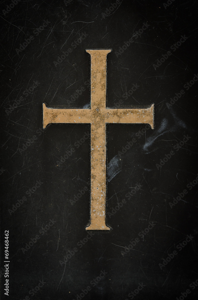 stone cross on black marble