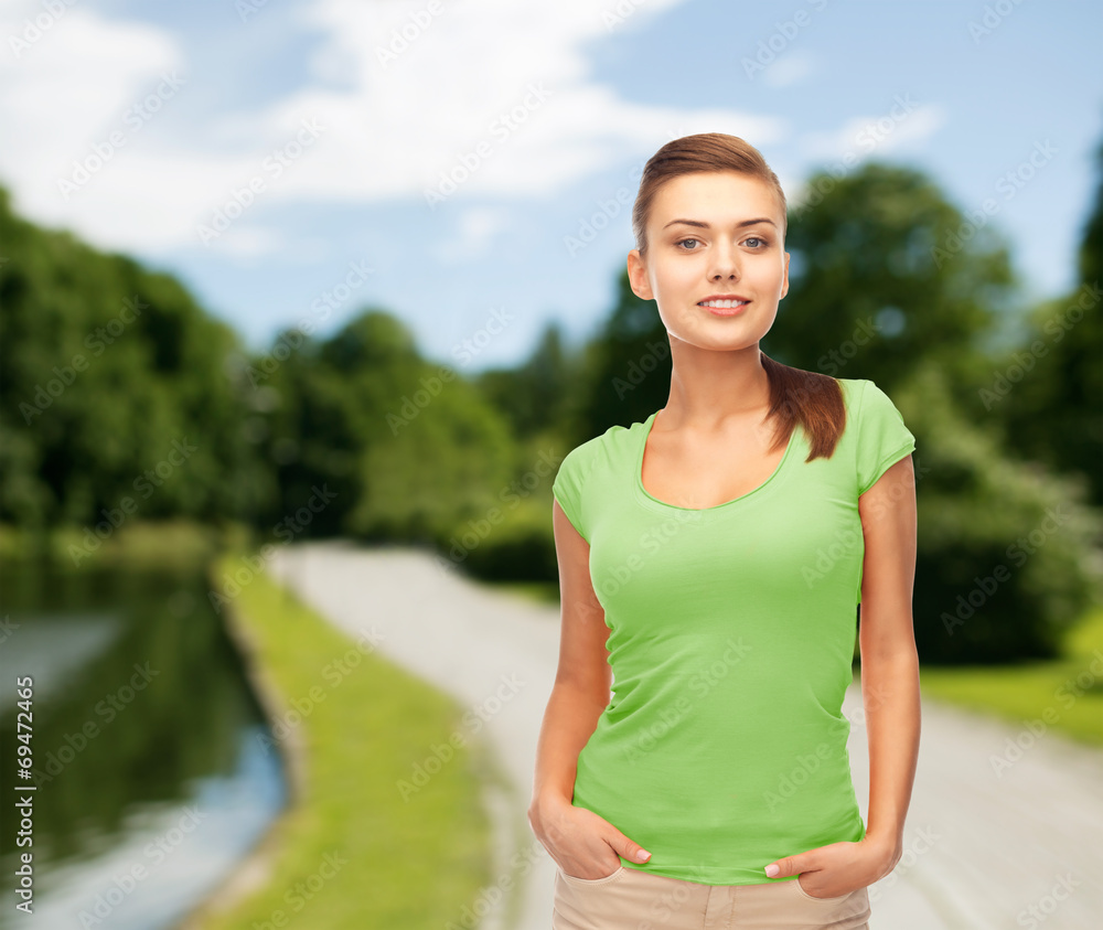 smiling young woman in blank green t-shirt smiling young woman in blank green t-shirt