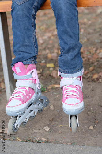 roller blades on the legs of child