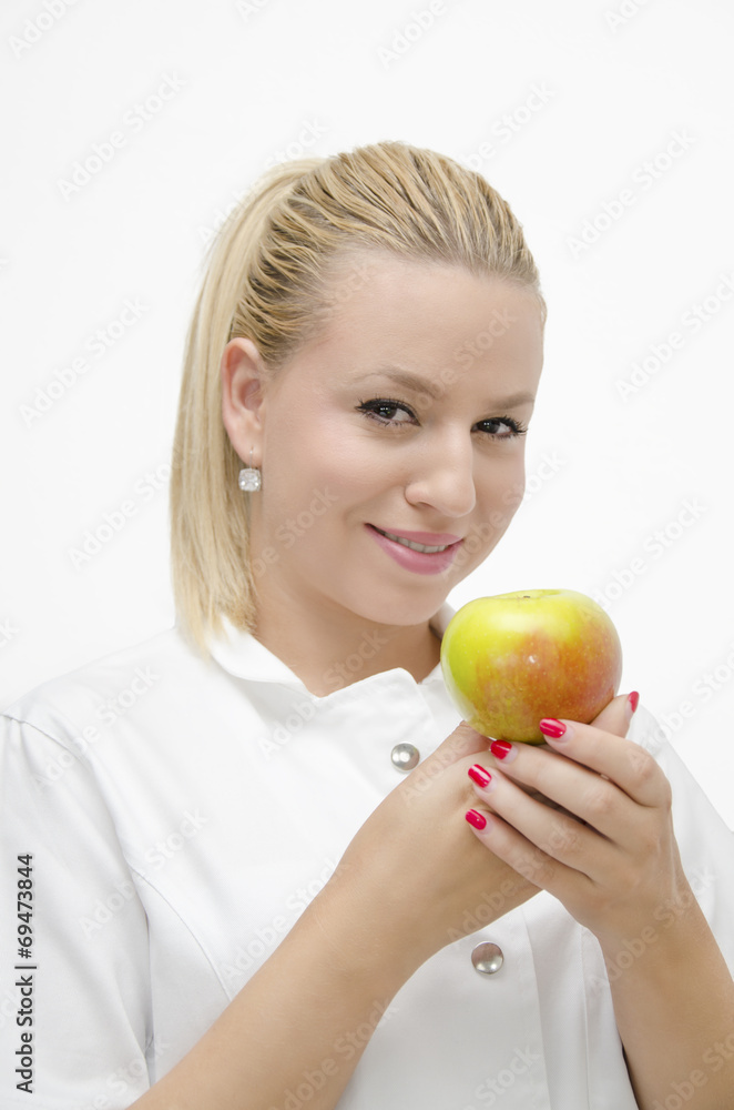 Smiley female doctor holding apple in her arms Smiley female doctor holding apple in her arms