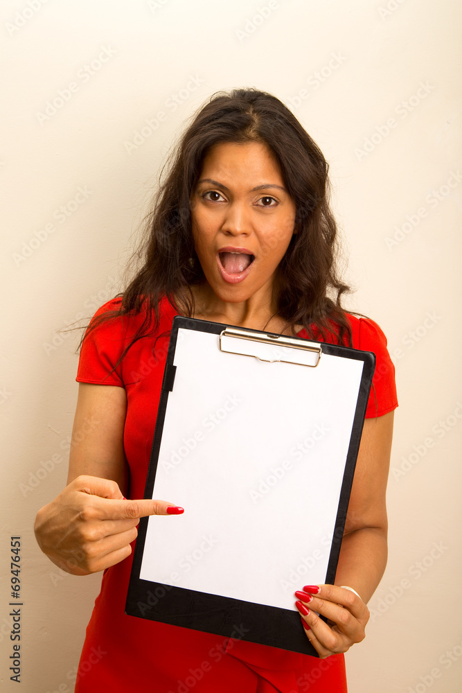 young woman looking surprised showing a clipboard. young woman looking surprised showing a clipboard.