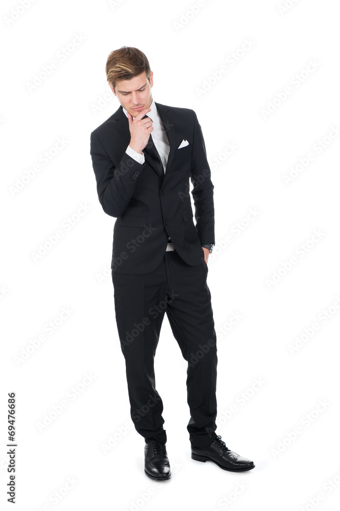 Thoughtful Businessman Standing With Hand On Chin Thoughtful Businessman Standing With Hand On Chin