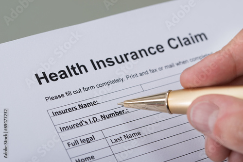 Hand Filling Health Insurance Form