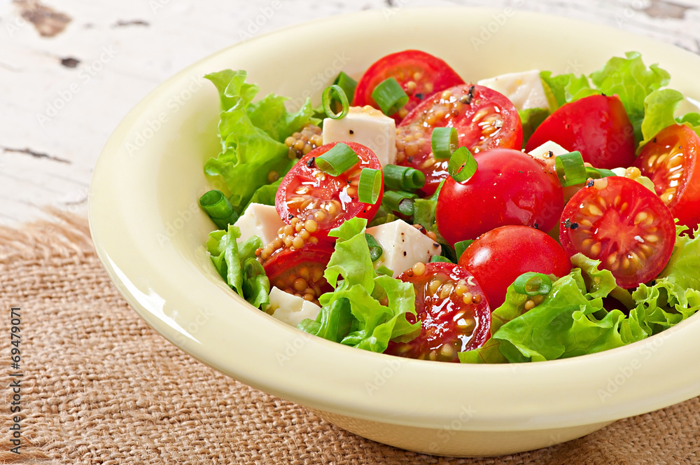 Tomato salad with lettuce, cheese and mustard and garlic dressin Tomato salad with lettuce, cheese and mustard and garlic dressin