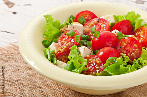 Tomato salad with lettuce, cheese and mustard and garlic dressin