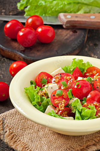 Tomato salad with lettuce, cheese and mustard and garlic dressin