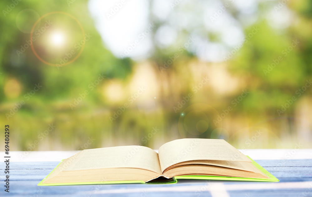 Open book on table outdoors Open book on table outdoors